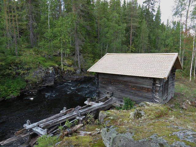 Photo of a grey wooden log building