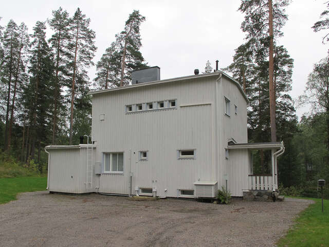 White wooden house with small windows.