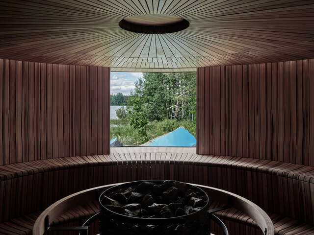Round sauna with detailed wooden ceiling.