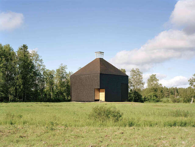 Contemporary wooden church in the middle of a grassfield