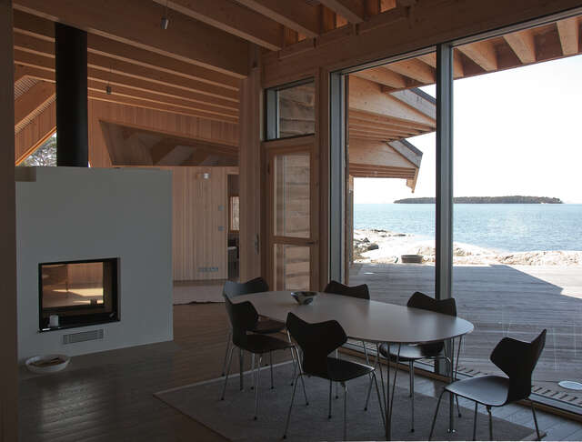 Fireplace and dinette next to a large window with views to the horizont