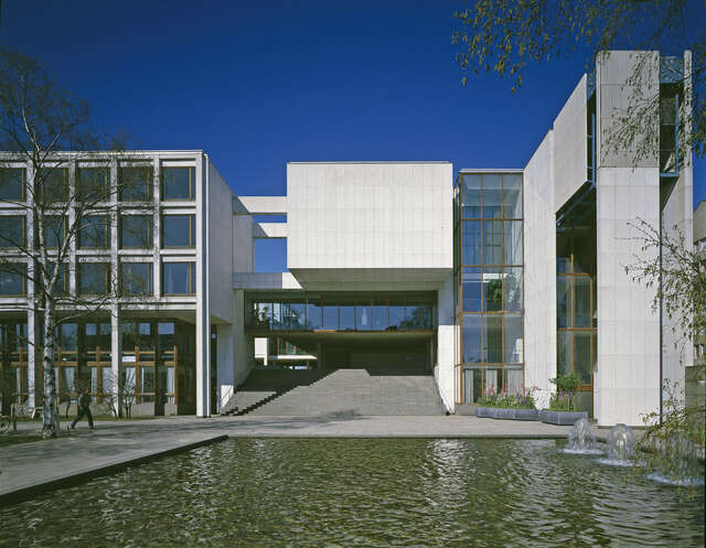 Office building behind a fountain and a square