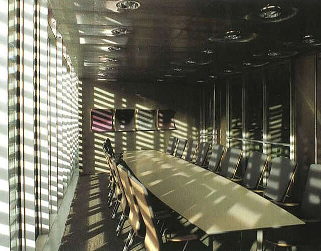 Conference room, table and chairs in the middle of the room.