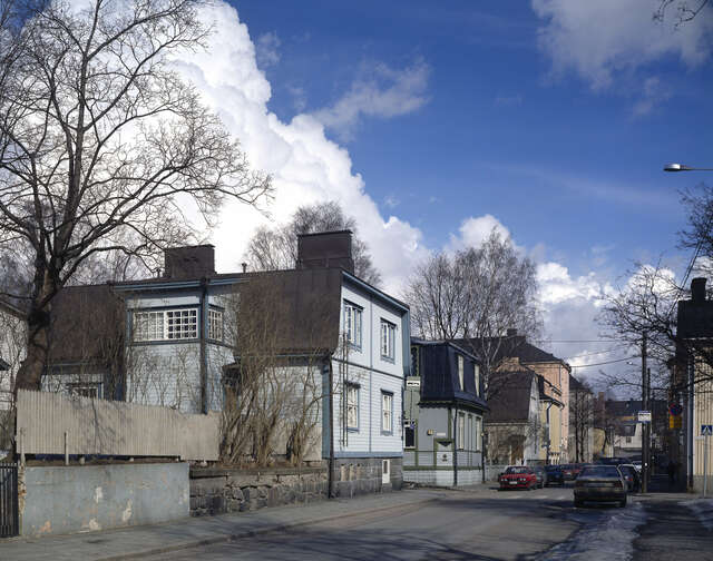 Blue wooden house with grid windows.