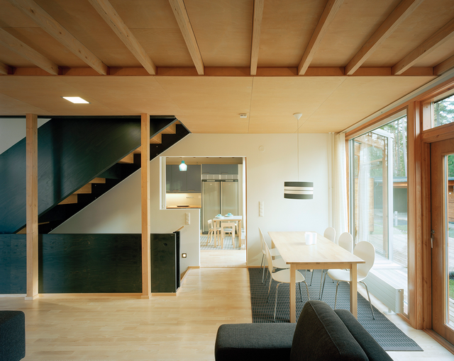 Photo inside of the building. There are stairs and a black bench