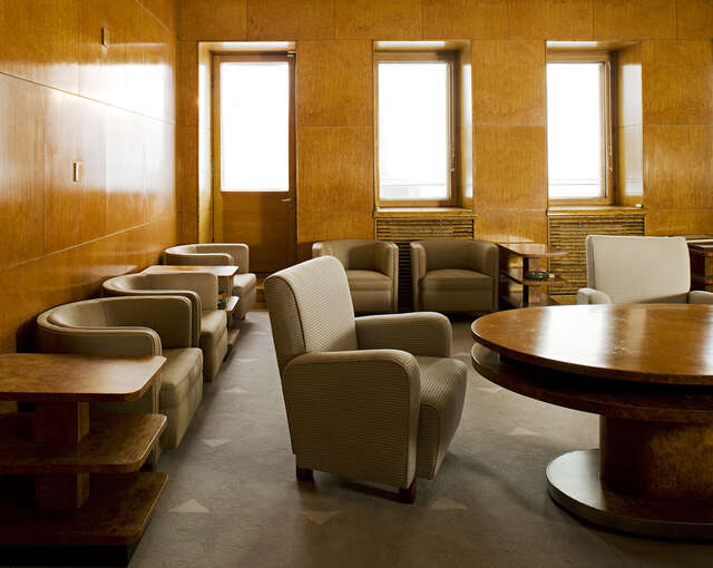 Armchairs in a wood covered room.