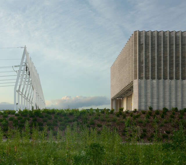Electrical power lines next to a square building.