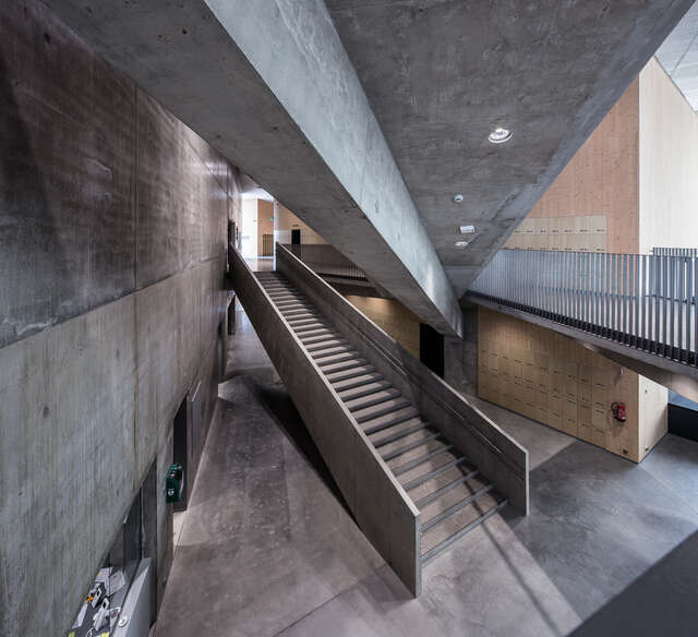 Classroom with moving chairs around round tables.