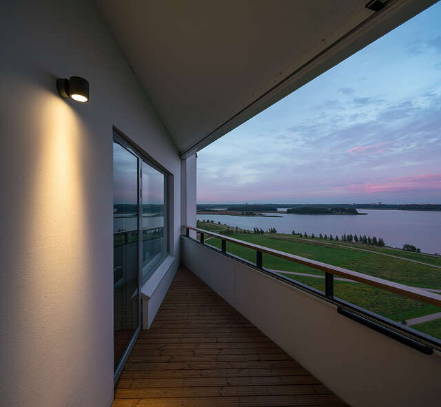 Interior of a triangular balcony with a view of the sea.