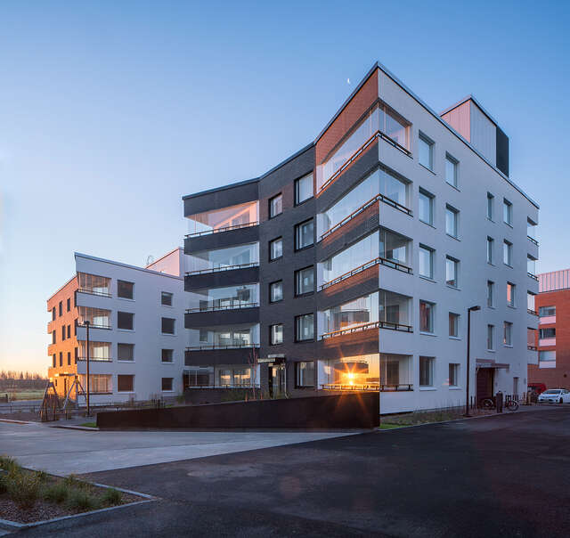 Black and white apartment building facade with sharp corners and no straight lines.