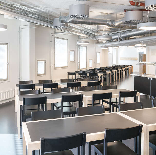 Canteen with black and white furniture.