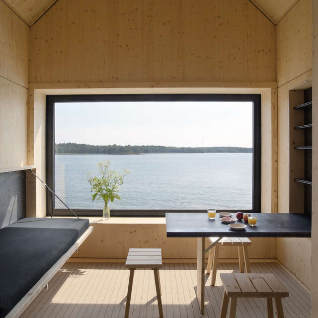View from inside a wooden cabin towards the sea