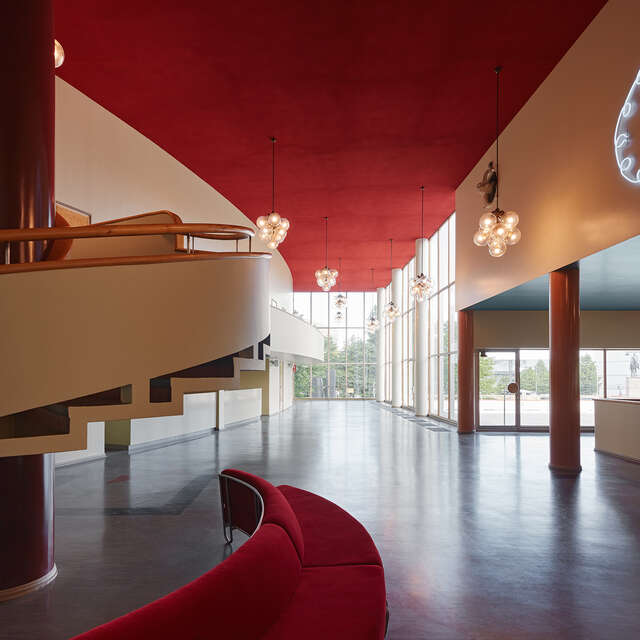 Interior with white walls, red details and a glazed wall.