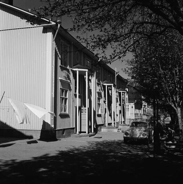 Row of wooden houses in a black and white picture.