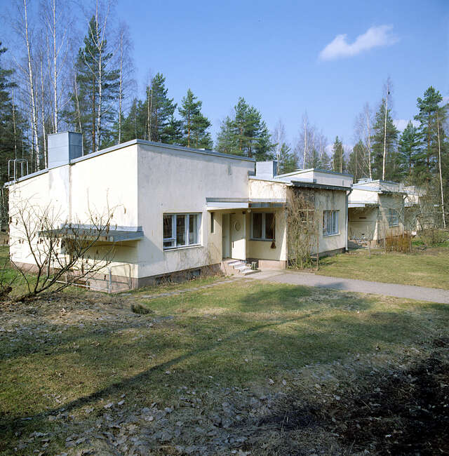 Functionalist row house surrounded by woods.