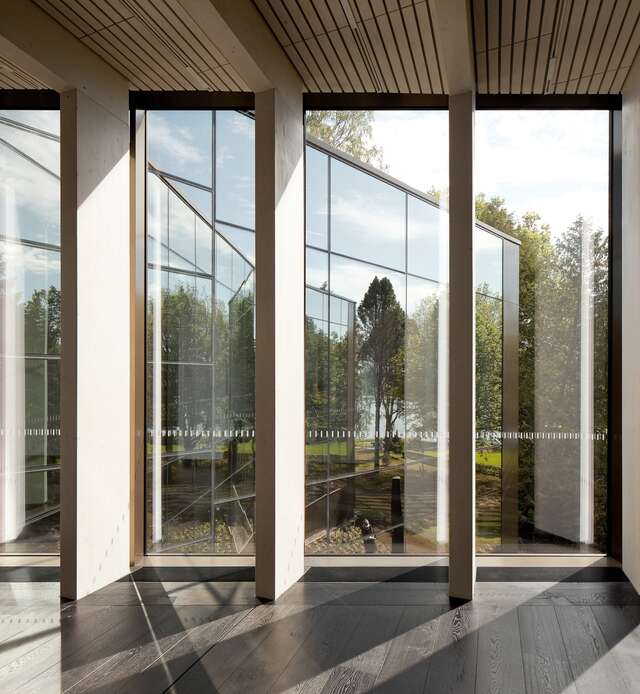 Wall with large windows and wooden support panels.
