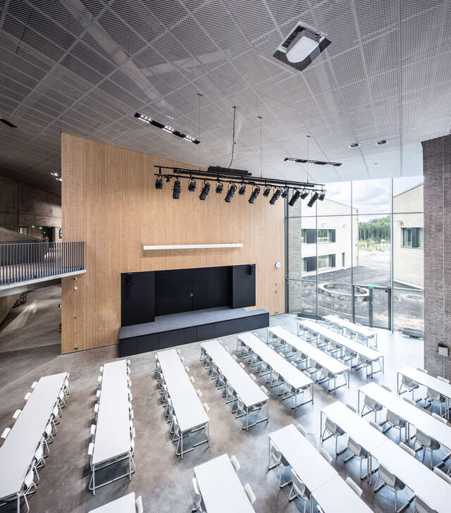 Classroom with white furniture and a large glass windows.