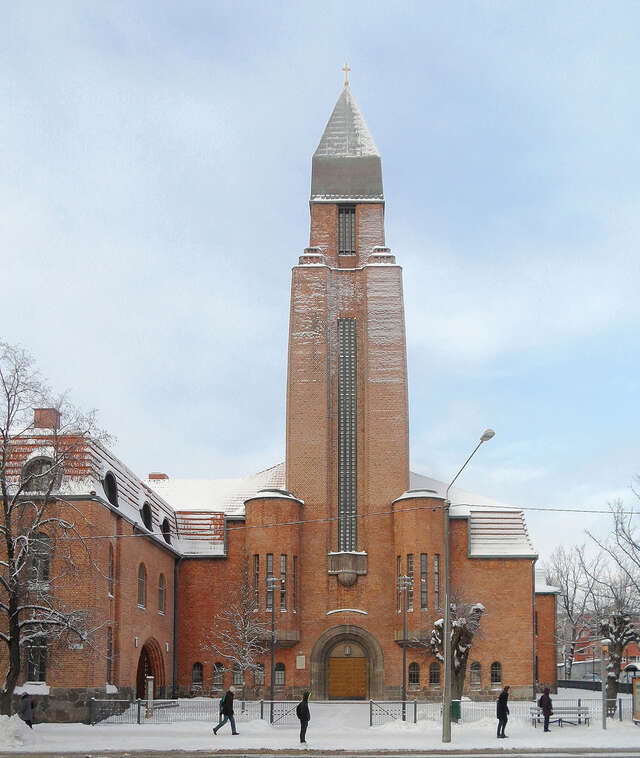 Red-brick exterior with a tower on a snowy day