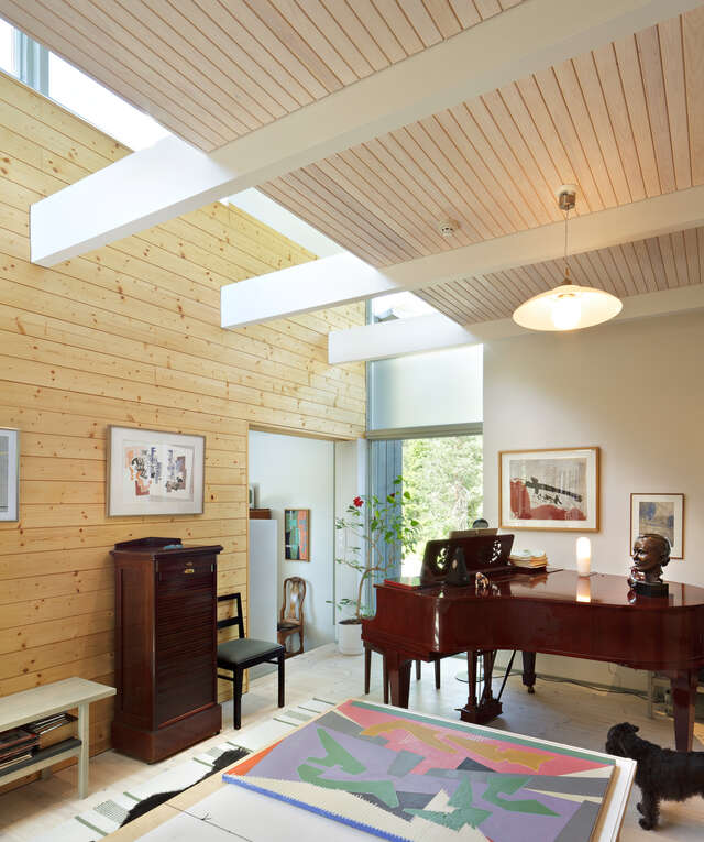 Grand piano in a wooden and white toned interior