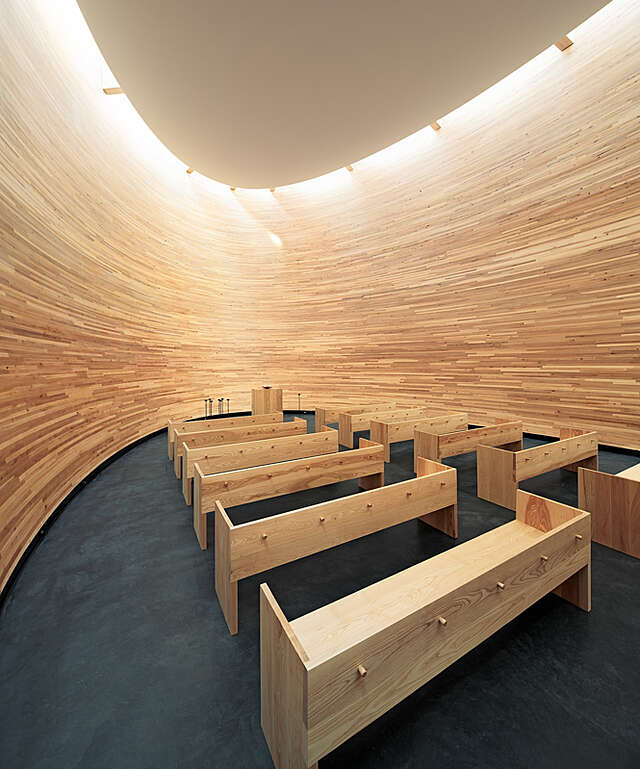Wooden interior of the curve-shaped chapel