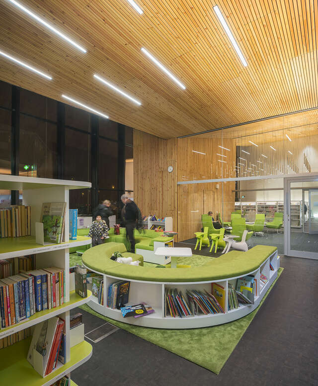 Green reading area next to the children's books.