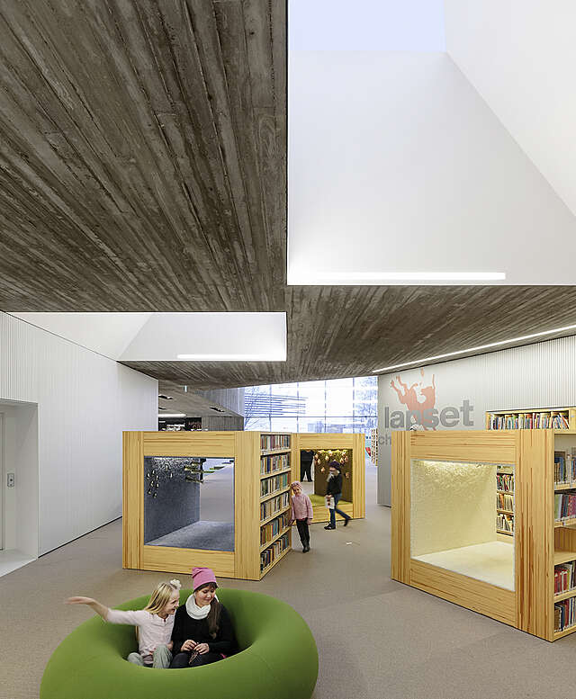 Children sitting, leaning and passing through the children's section, concrete and white ceiling elements