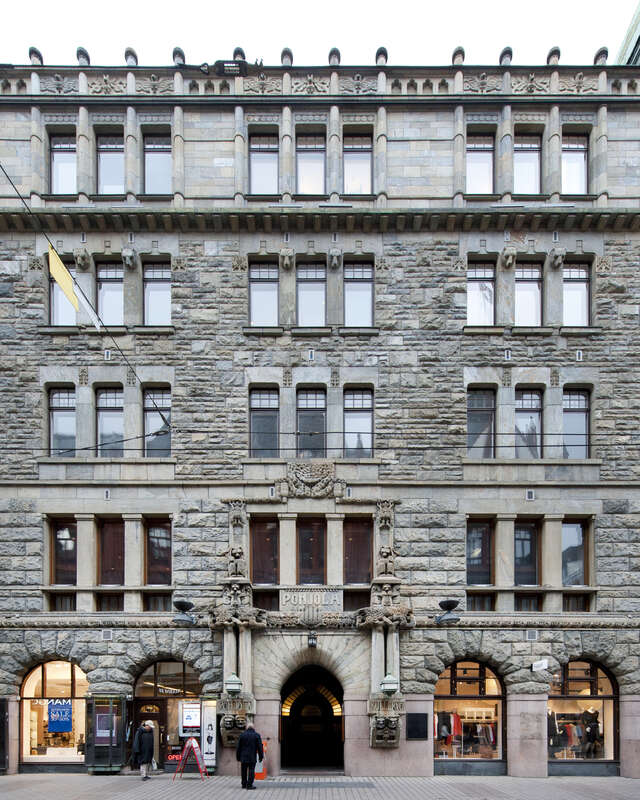 Old stone building with decorations and sculptures depicting creatures of nordic mythology.