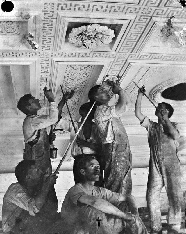 Men are painting a ceiling