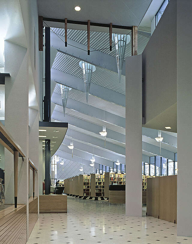 Spacious entrance hall and library with high ceilings.