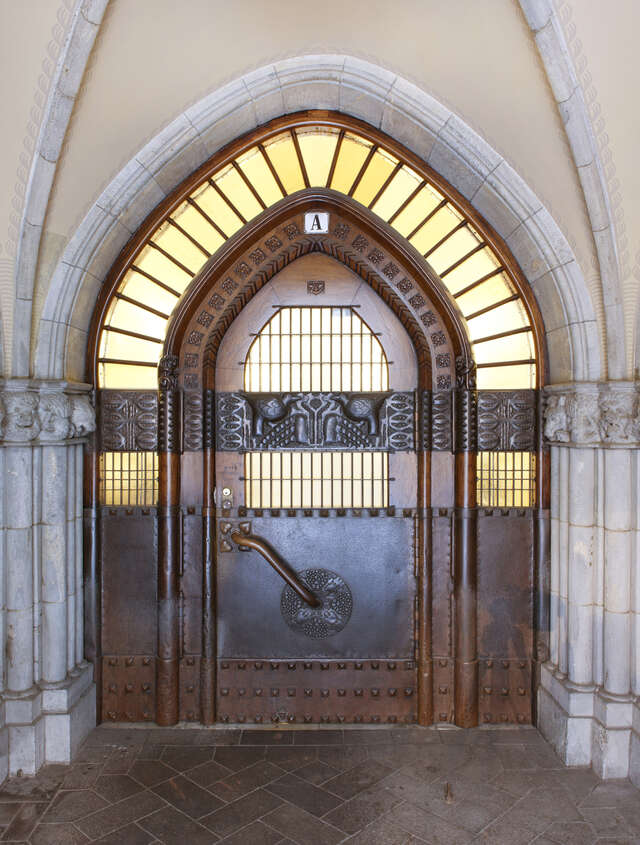 Arched door with metal, wood and glass details.