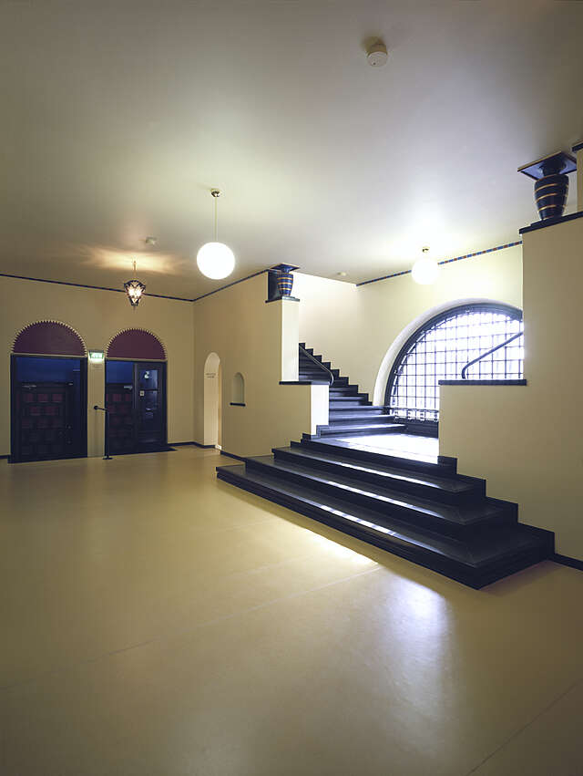 white interior with blue stairs and decorative elements
