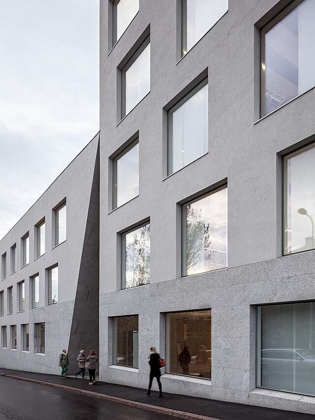 Grey exterior with large square windows.