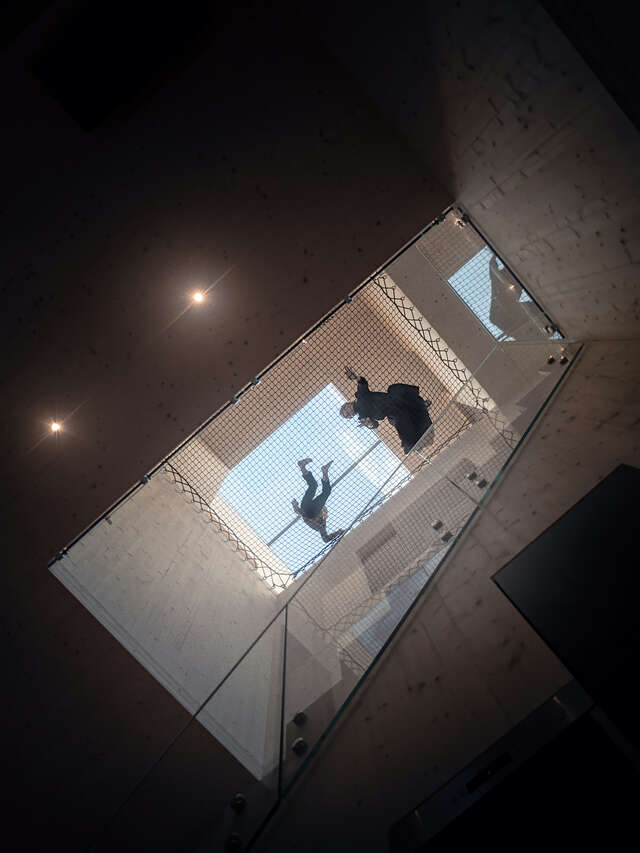 View of staircase looking up from ground floor. Skylight seen at very top.