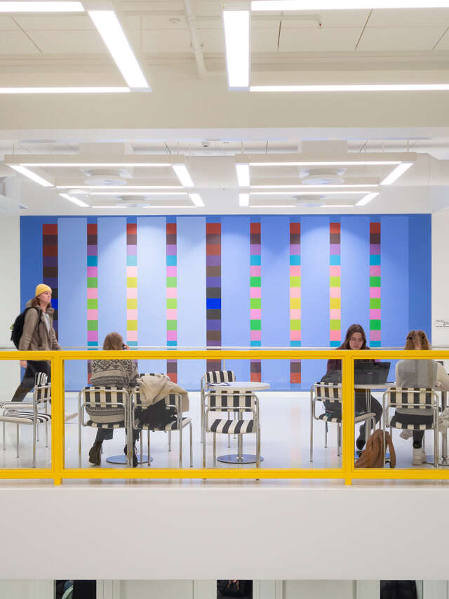 View of a library corridor with yellow railings.