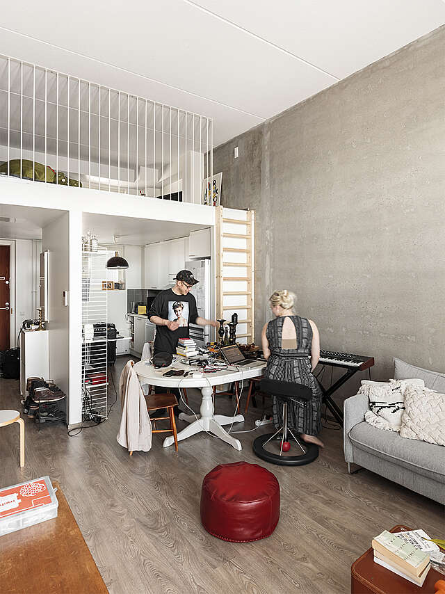 Two musicians with a workspace in the middle of the room.