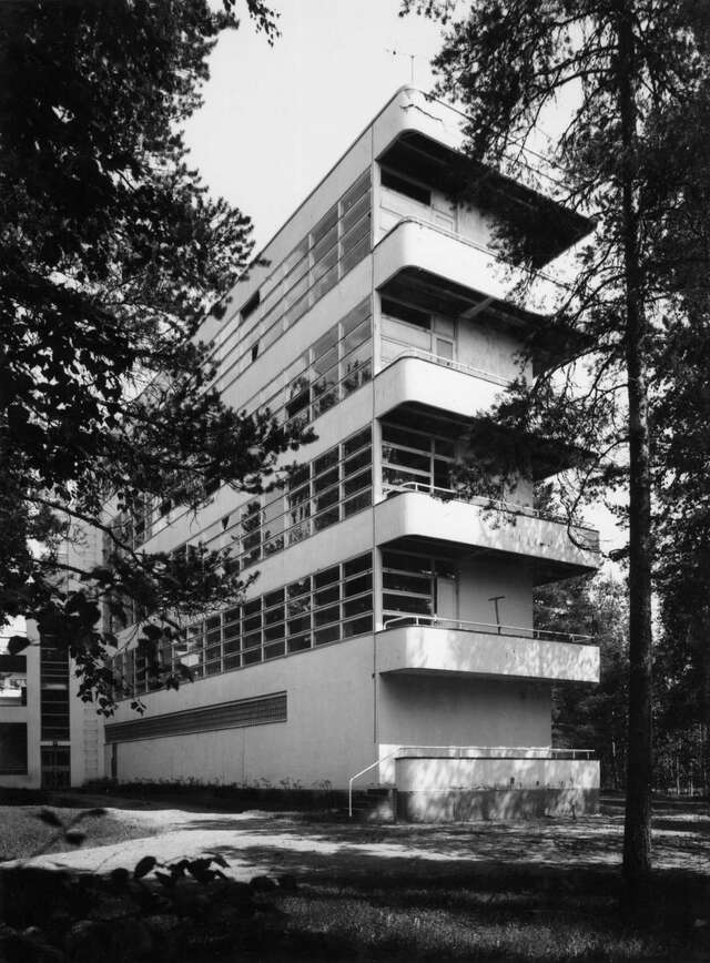 Functionalist hospital building surrounded by woods.