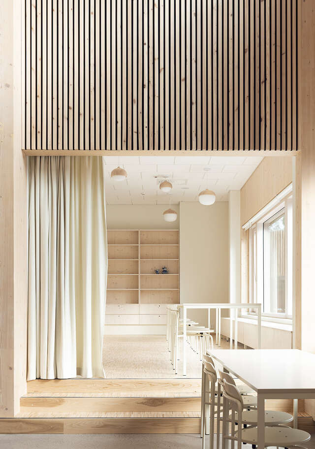 Wooden entranceway with tables and a curtain.