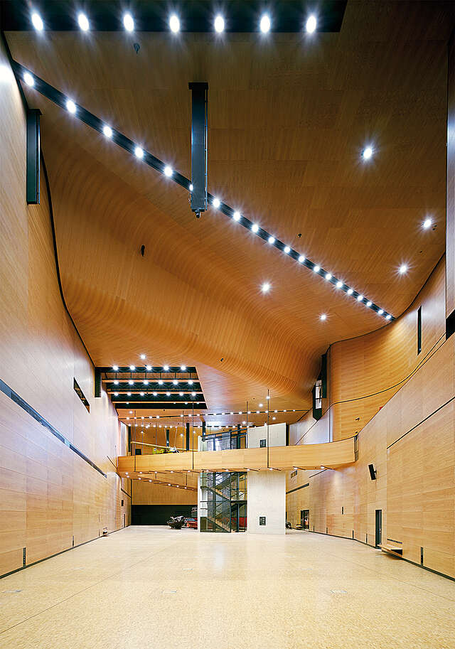 Wooden interior with a wavy ceiling.