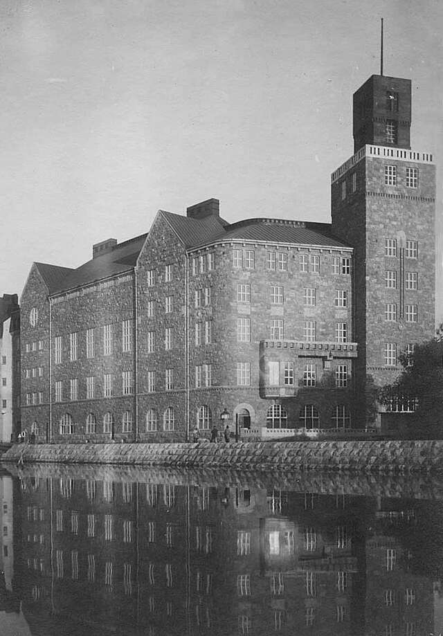 Facade of a stone building next to the sea.