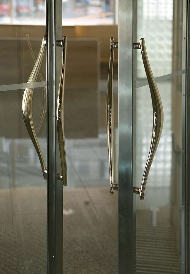 Curved golden doorhandles.