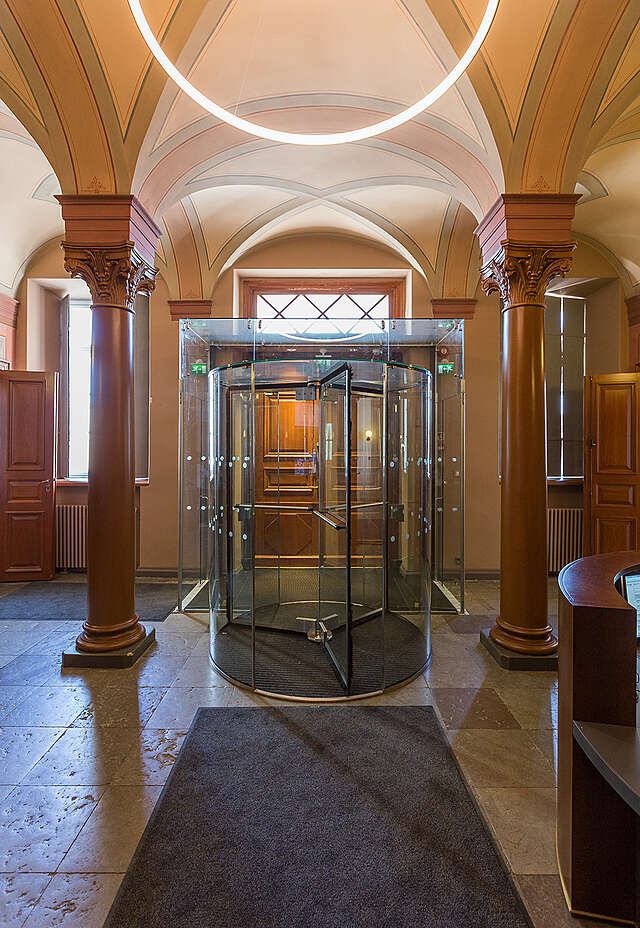 Glass turning doors in an old ornate entrance hall.