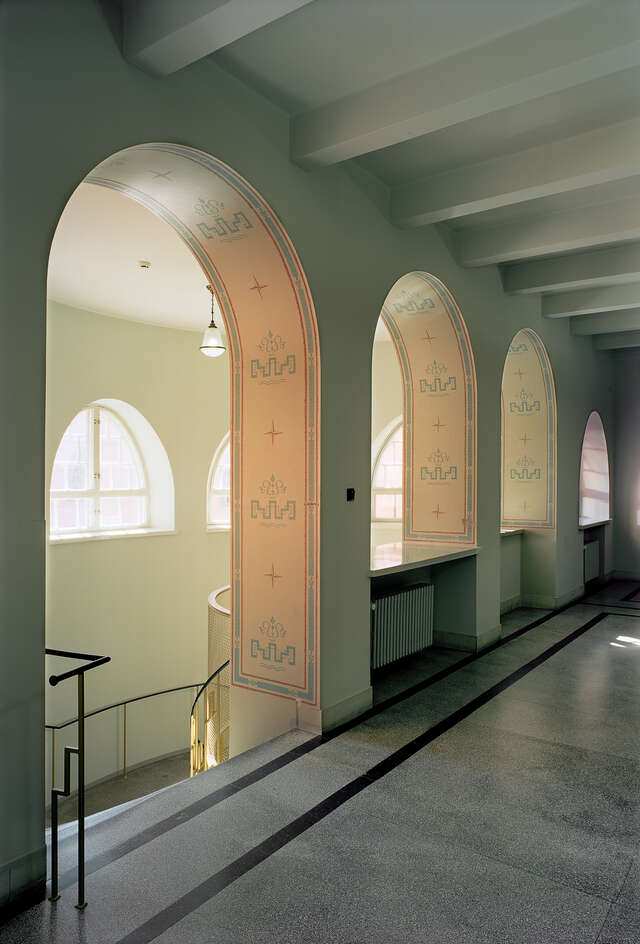 Row of arches towards a descending staircase