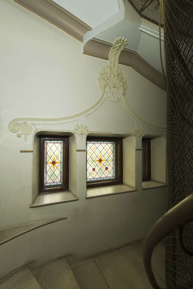 Trained glass windows in a stairway.