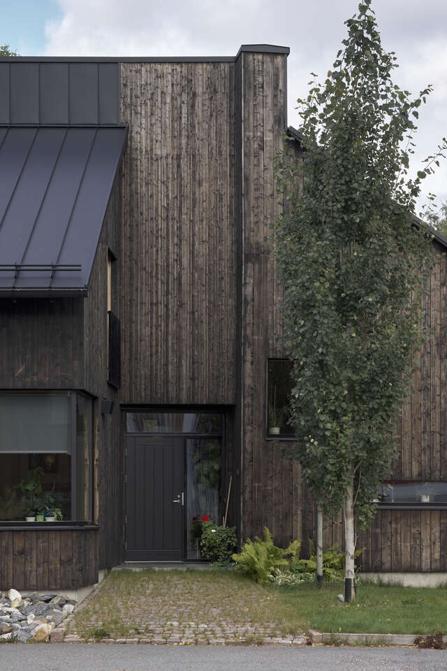 The entrance of a large wooden house