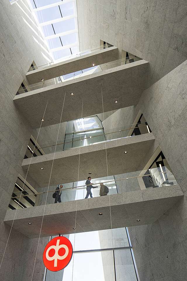 Grey stone interior with hallways connecting different sides of the building like bridges.