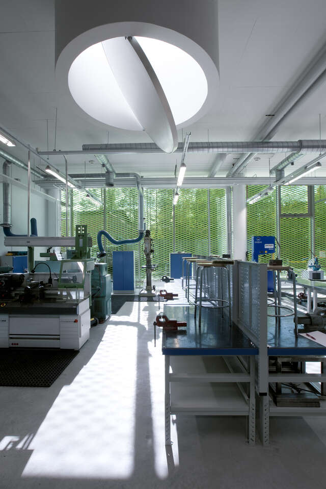 Work space with machines, light gap from the ceiling and glazed backside