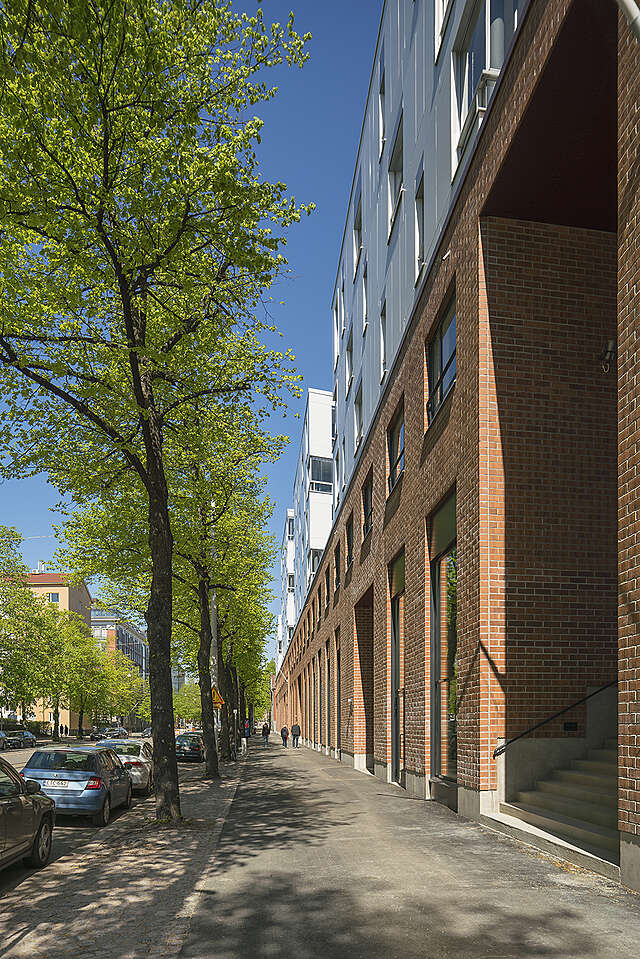 Red-brick building white white upper floors.