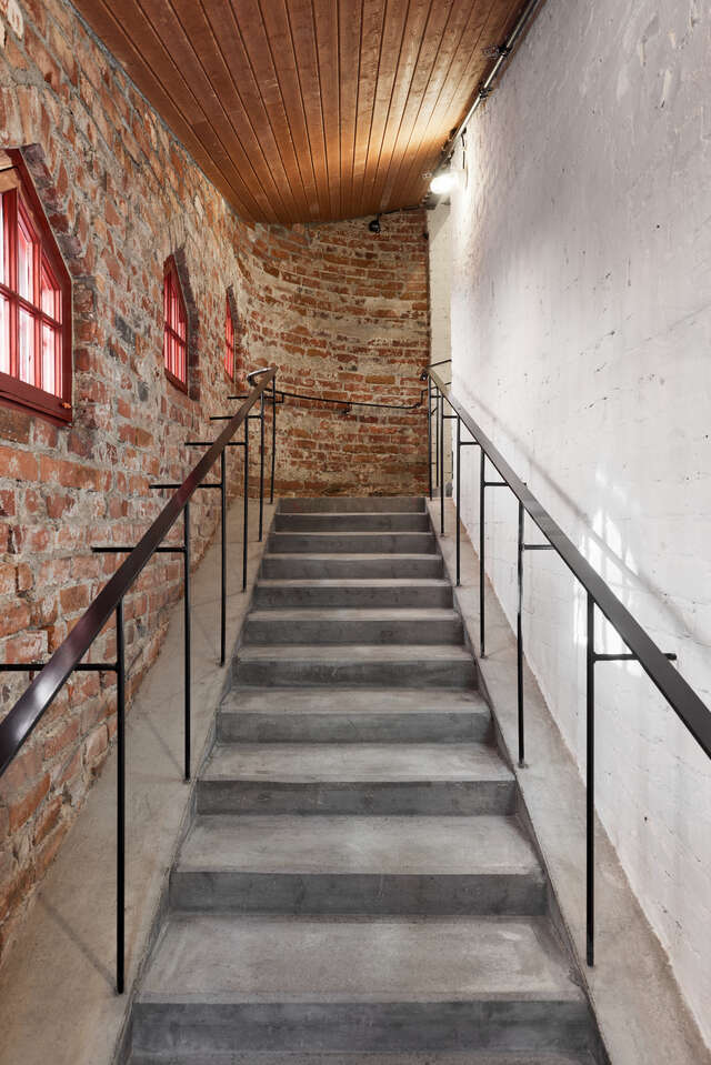 Narrow staircase in an old brick building.