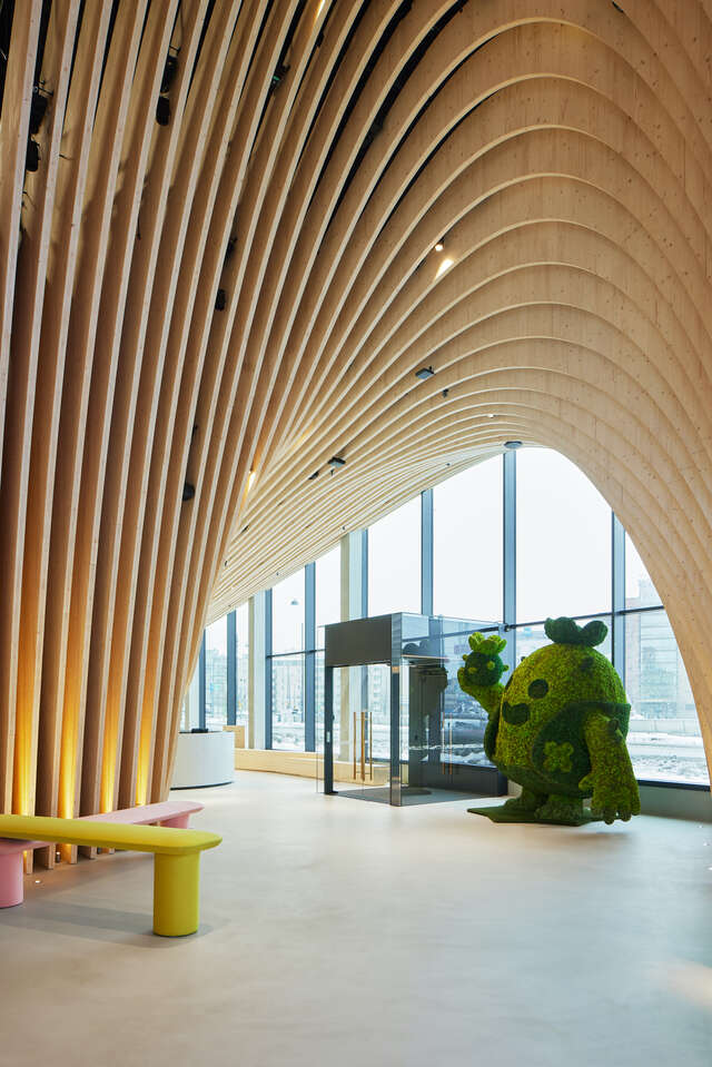 Wooden curvy structure interior with windows.