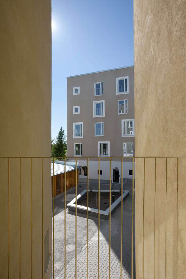 Peak from a french balcony towards the courtyard and neighbour block house